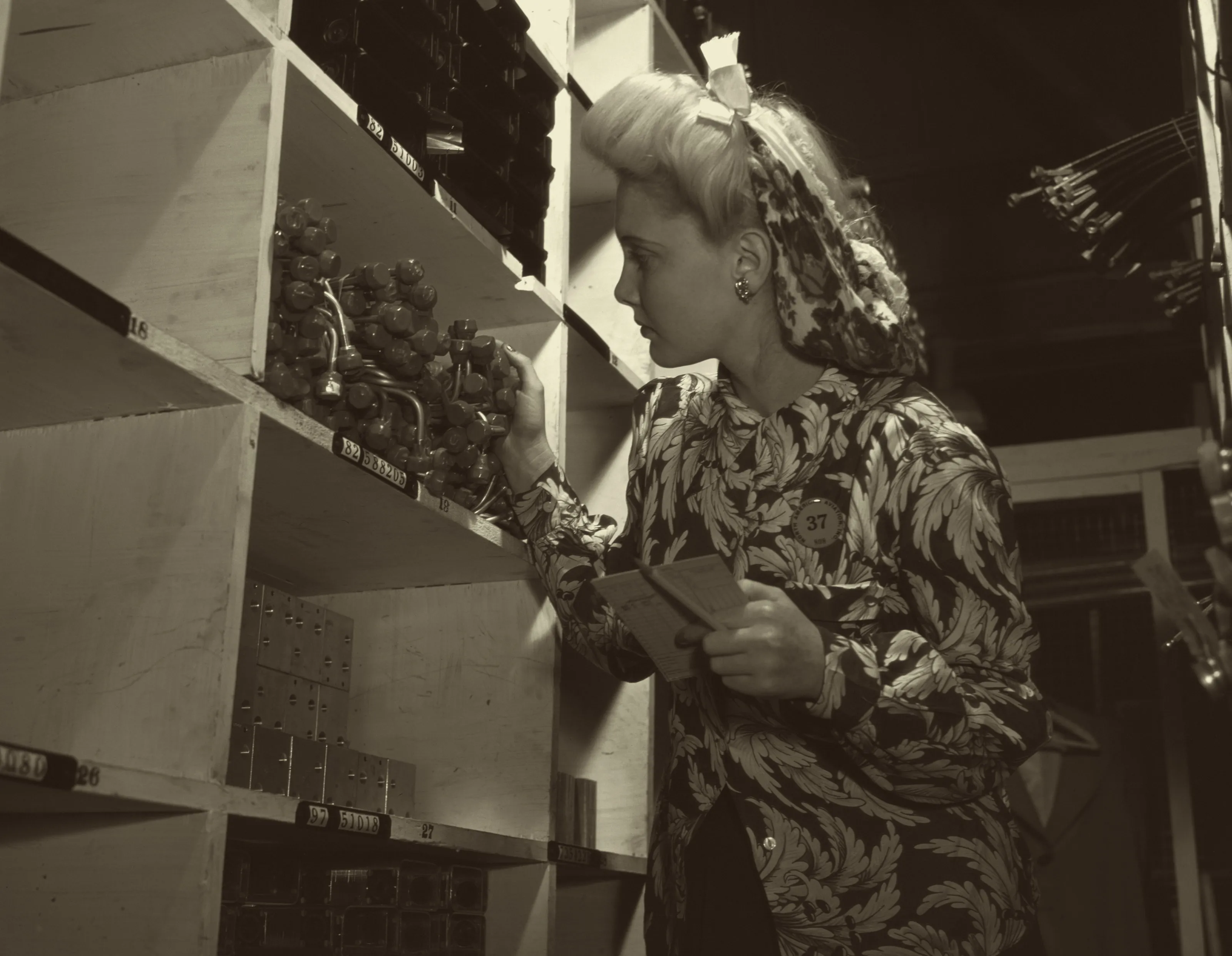 Stock room clerk checking parts, North American Aviation, Inglewood, California, October 1942